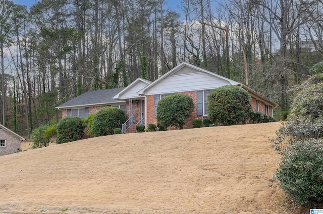 ranch-style house featuring brick siding and a front lawn