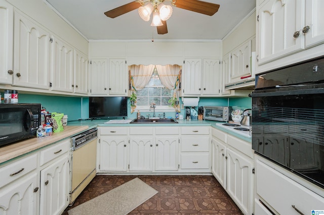 kitchen featuring dark floors, a toaster, light countertops, a sink, and black appliances