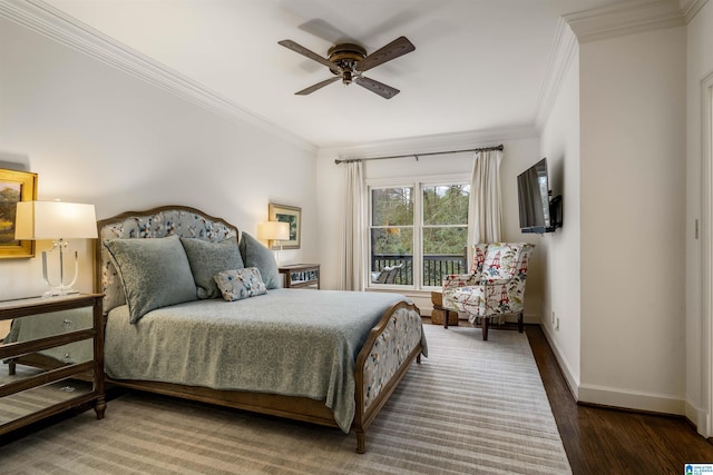 bedroom with a ceiling fan, crown molding, baseboards, and wood finished floors