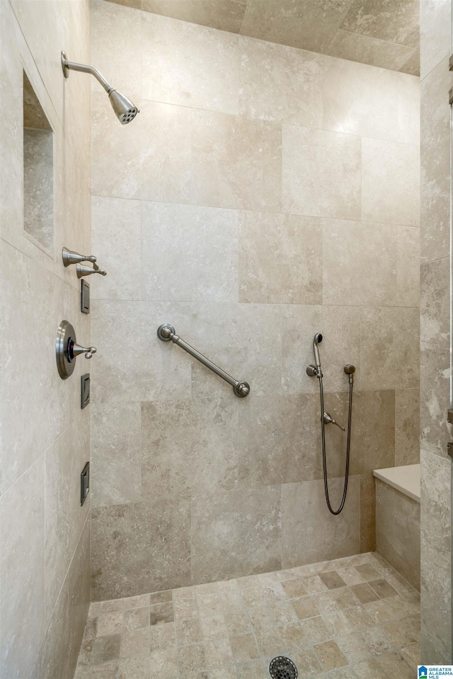 bathroom with tiled shower