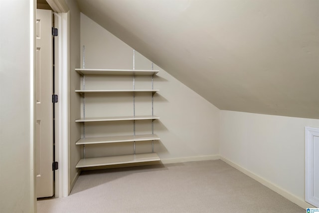 interior space with vaulted ceiling and carpet flooring