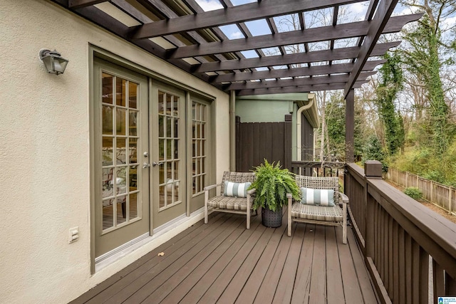 wooden terrace featuring french doors and a pergola