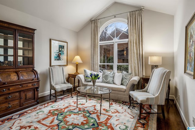 sitting room with lofted ceiling, wood finished floors, and baseboards