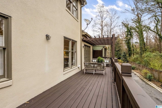 wooden deck with a pergola, outdoor lounge area, and fence