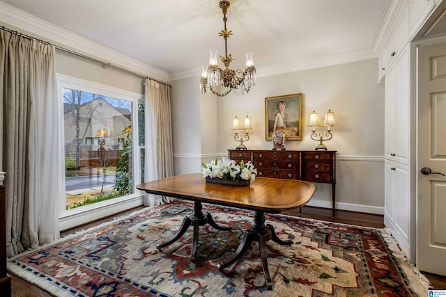 office featuring baseboards, wood finished floors, an inviting chandelier, and ornamental molding