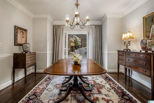 dining room featuring dark wood finished floors, crown molding, baseboards, and a chandelier