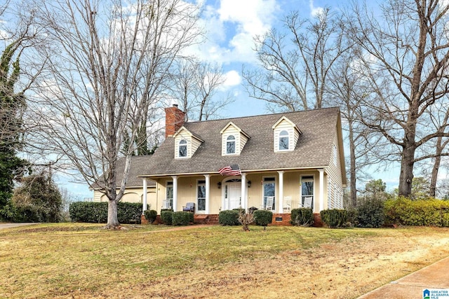 new england style home featuring a shingled roof, a chimney, crawl space, covered porch, and a front yard