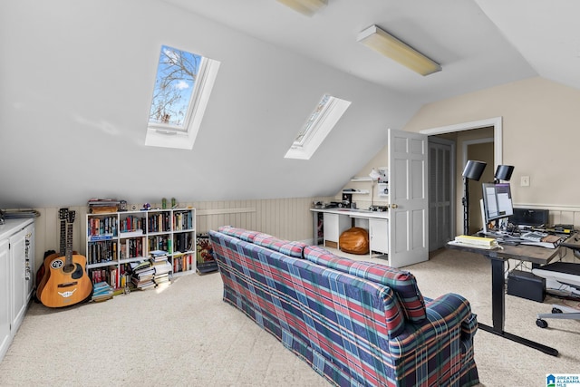 office with lofted ceiling with skylight, carpet, and a wealth of natural light