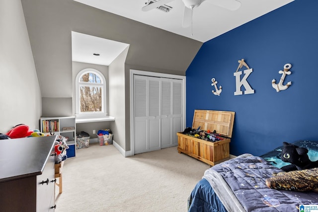 carpeted bedroom featuring baseboards, visible vents, a ceiling fan, lofted ceiling, and a closet