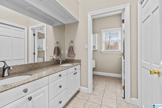 bathroom featuring tile patterned flooring, a sink, and toilet