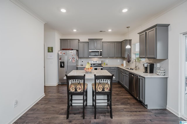 kitchen with dark wood-style flooring, a sink, stainless steel appliances, gray cabinetry, and backsplash