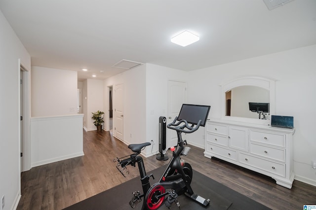 exercise area with visible vents, baseboards, and dark wood-style flooring