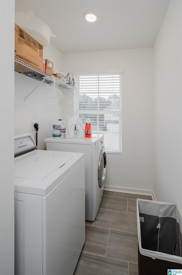 laundry room with washing machine and dryer, laundry area, and baseboards