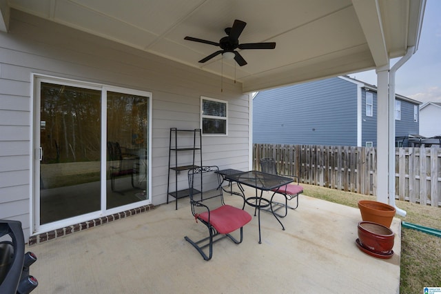 view of patio / terrace with outdoor dining area, ceiling fan, and fence