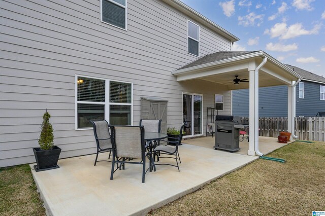 view of patio featuring outdoor dining area, ceiling fan, grilling area, and fence