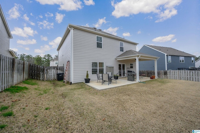 back of house featuring a patio, a yard, and a fenced backyard