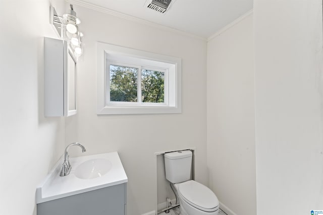 bathroom featuring toilet, vanity, visible vents, and crown molding