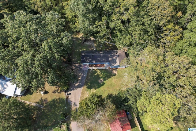 drone / aerial view featuring a wooded view