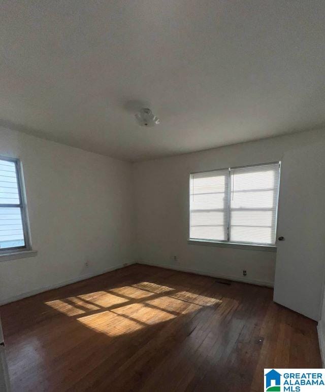 spare room featuring wood finished floors