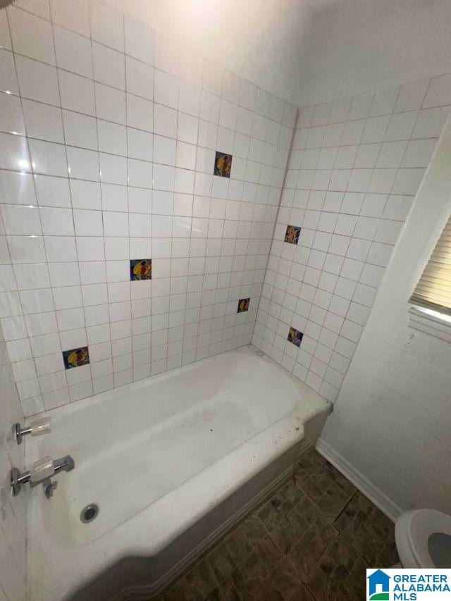 bathroom with shower / bathtub combination and toilet