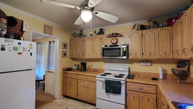 kitchen with ceiling fan, white appliances, light countertops, ornamental molding, and light floors