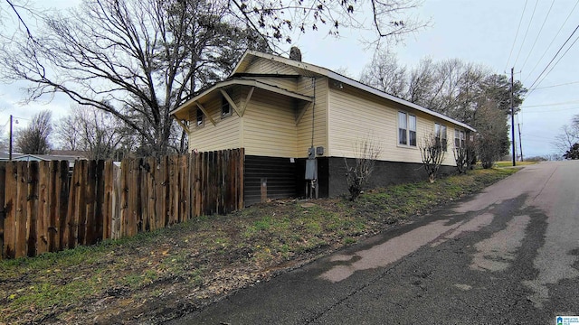 view of home's exterior featuring fence