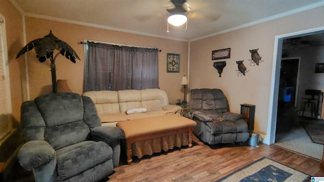 living room featuring a ceiling fan, ornamental molding, and wood finished floors