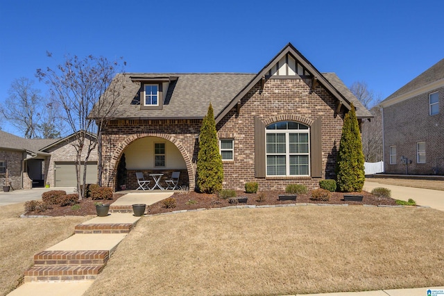 view of front of house featuring an attached garage, a shingled roof, concrete driveway, and brick siding