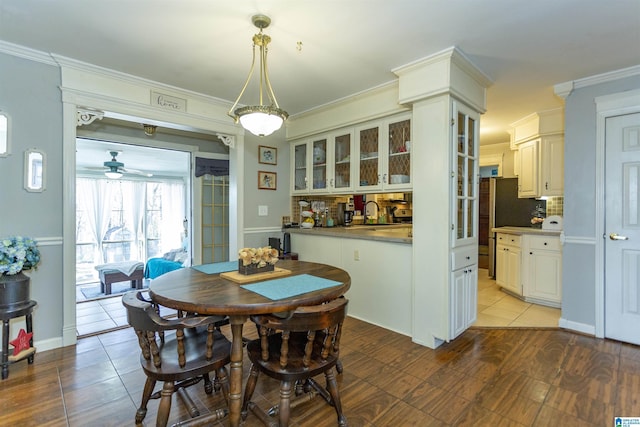 dining area featuring tile patterned floors and crown molding