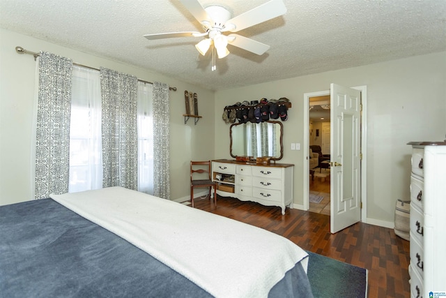 bedroom featuring a ceiling fan, baseboards, a textured ceiling, and wood finished floors