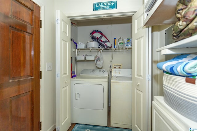 clothes washing area with washer and dryer and laundry area