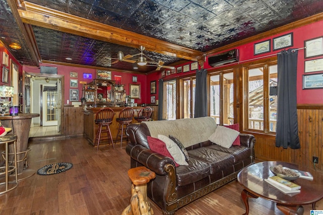 living area with plenty of natural light, a dry bar, wood-type flooring, and an ornate ceiling