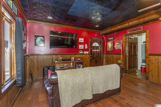 home theater featuring an ornate ceiling, wainscoting, and wooden walls