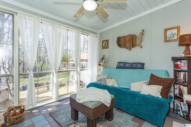 tiled living area featuring ceiling fan, ornamental molding, and wooden ceiling