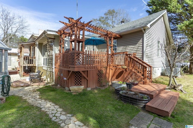 back of house featuring roof with shingles, a yard, stairway, a pergola, and a wooden deck