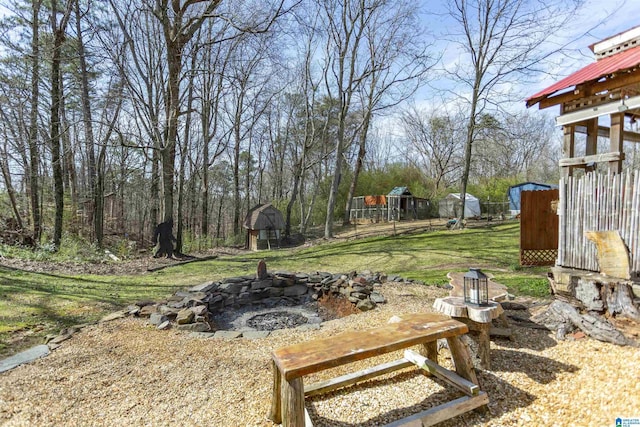 view of yard with an outdoor fire pit, an outdoor structure, and a shed