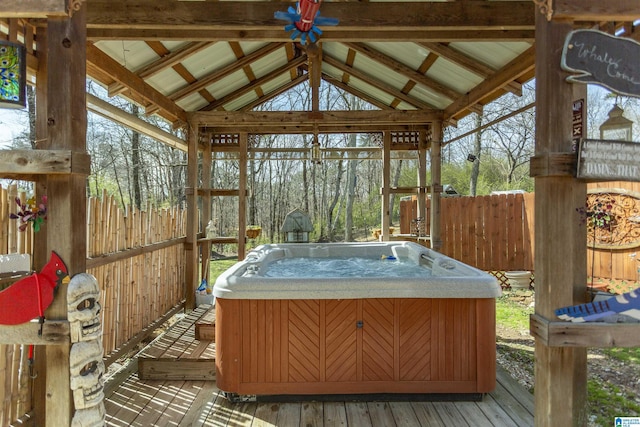 sunroom / solarium featuring lofted ceiling with beams and a hot tub