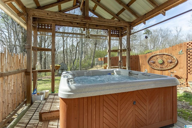 sunroom with lofted ceiling and a hot tub