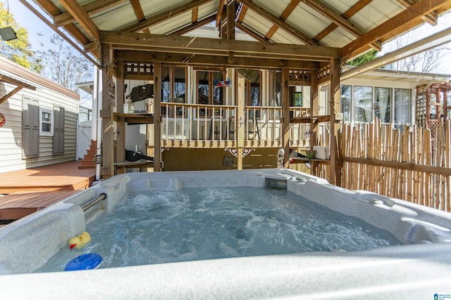 wooden deck with a hot tub