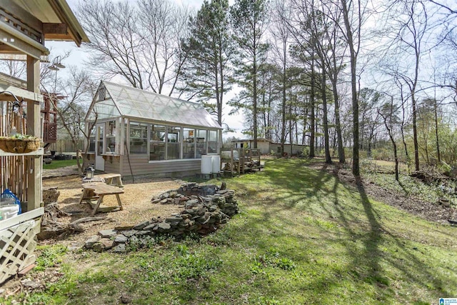 view of yard featuring an outdoor structure and an exterior structure