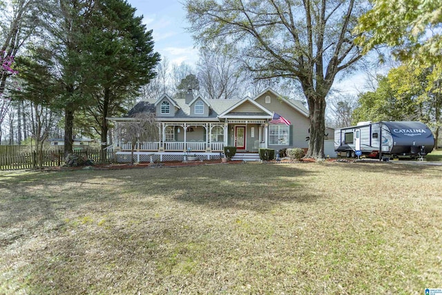 view of front of home featuring covered porch, a front yard, and fence