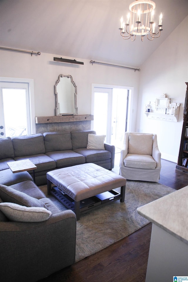 living area featuring high vaulted ceiling, dark wood finished floors, a wealth of natural light, and a notable chandelier