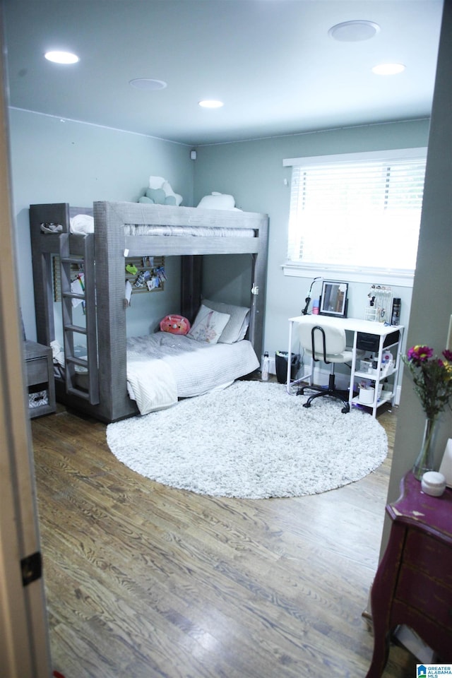 bedroom featuring wood finished floors and recessed lighting