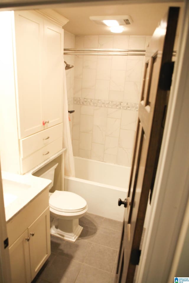 full bathroom with shower / bath combination with curtain, tile patterned flooring, vanity, and toilet