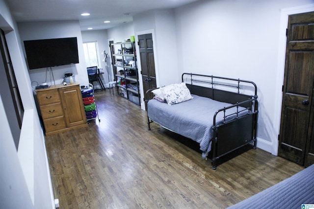 bedroom with recessed lighting, baseboards, and wood finished floors