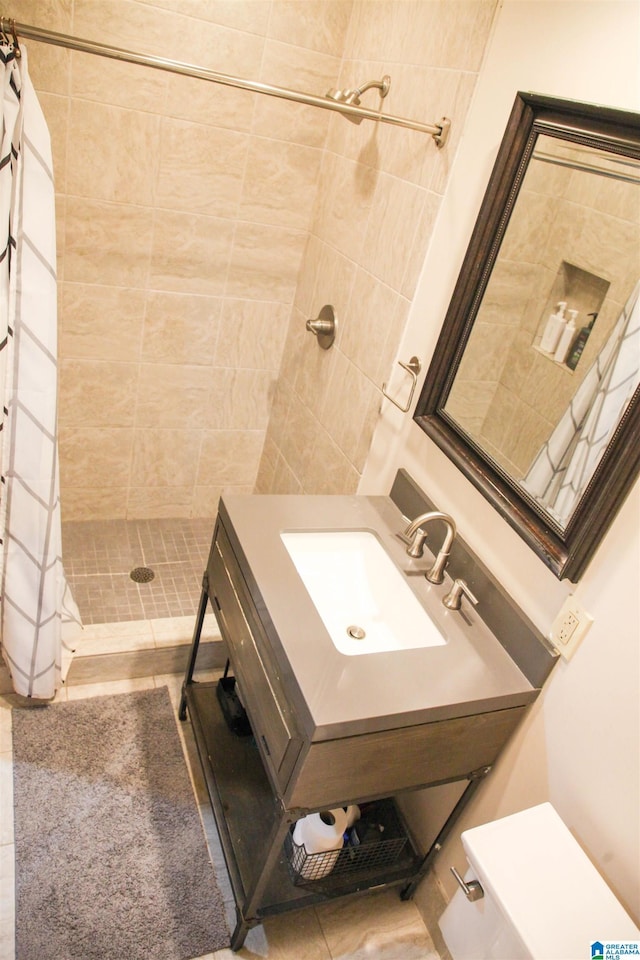 bathroom with a sink, tile patterned flooring, a shower stall, and toilet