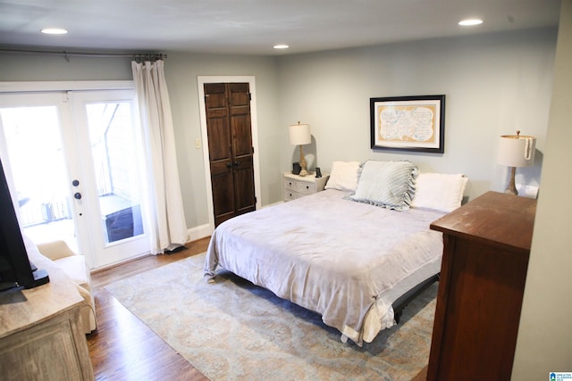 bedroom featuring access to outside, french doors, recessed lighting, and wood finished floors