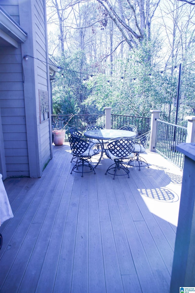 wooden deck featuring outdoor dining area