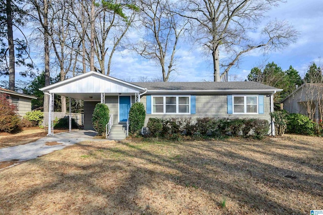 view of front of property featuring driveway, a carport, and board and batten siding