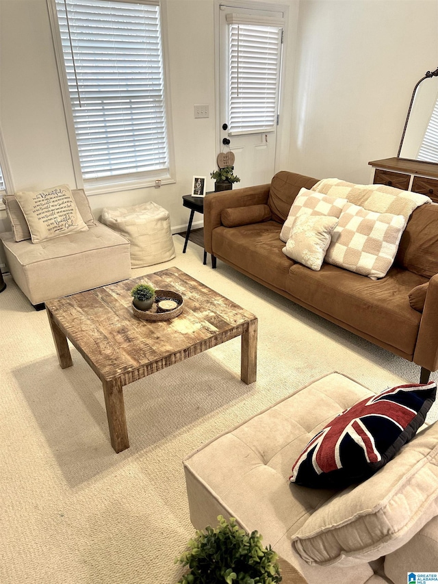carpeted living room with baseboards